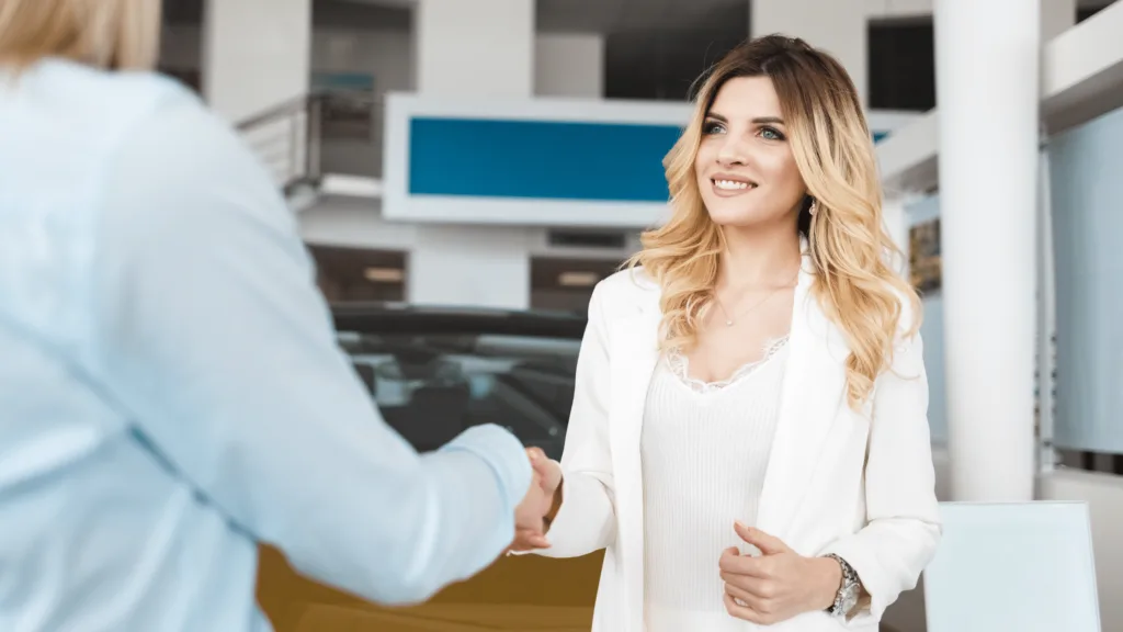 a woman shaking hands with a man